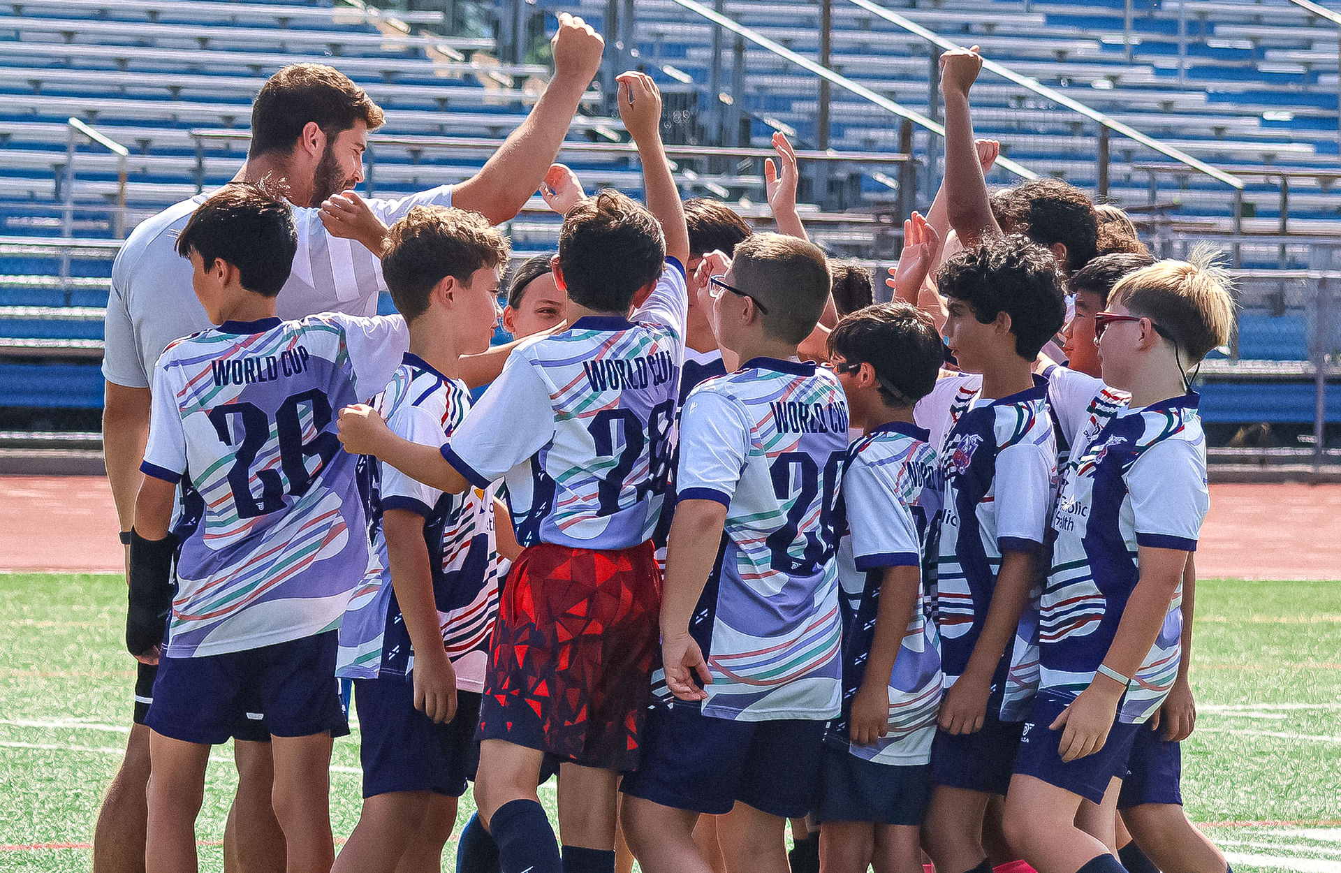 long island rough riders soccer players in camp huddle